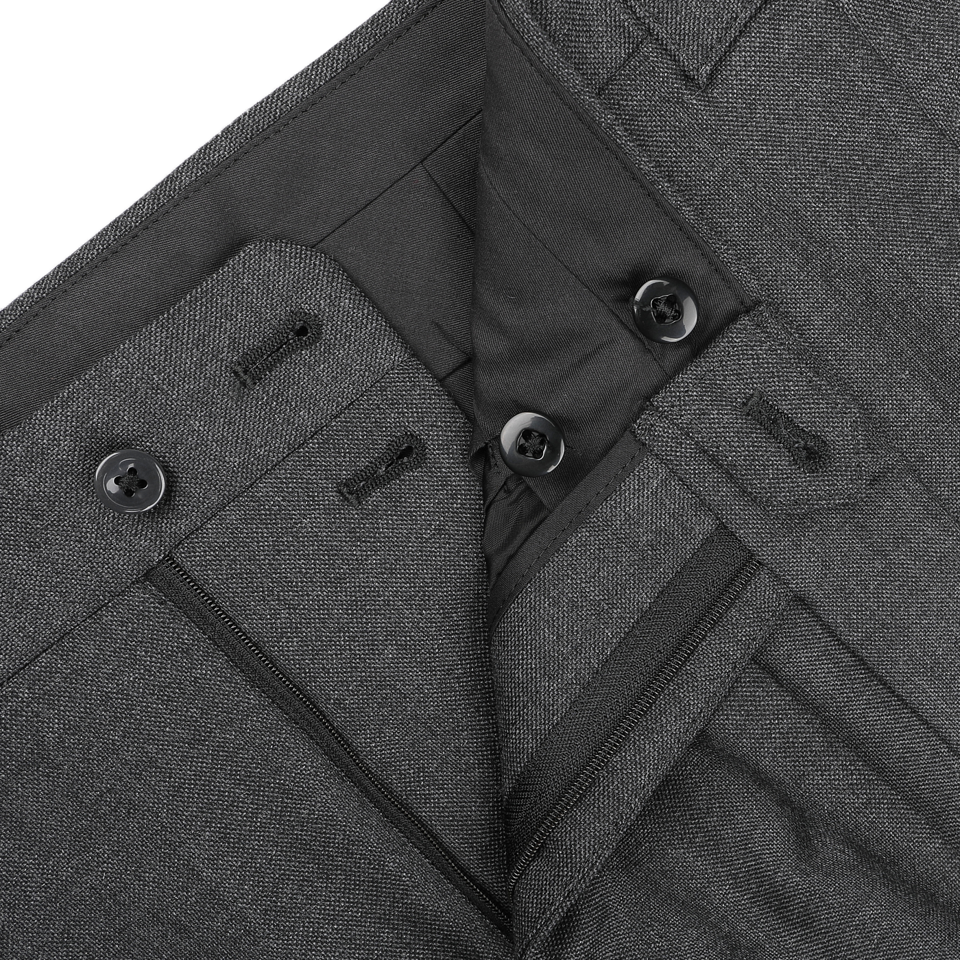 Close-up of the waistband of dark gray wool trousers from the Grey Calm Twist Wool DB Suit by Ring Jacket, featuring button closures and functional belt loops.