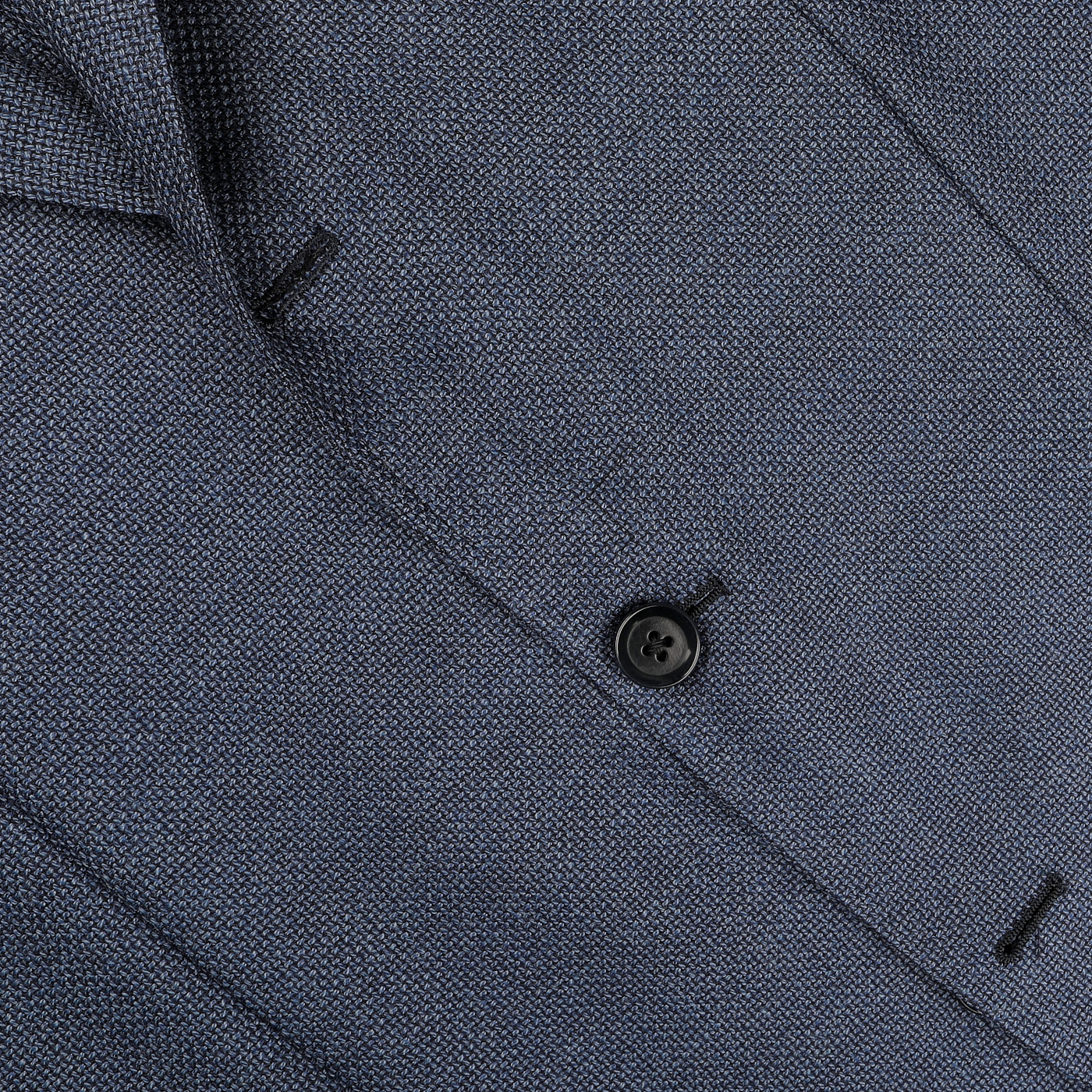 Close-up of the Denim Blue Wool Balloon Travel Blazer by Ring Jacket, featuring a textured open-weave design with a black button fastening, ideal as a versatile sports coat.