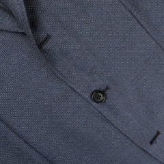 Close-up of the Denim Blue Wool Balloon Travel Blazer by Ring Jacket, featuring a textured open-weave design with a black button fastening, ideal as a versatile sports coat.