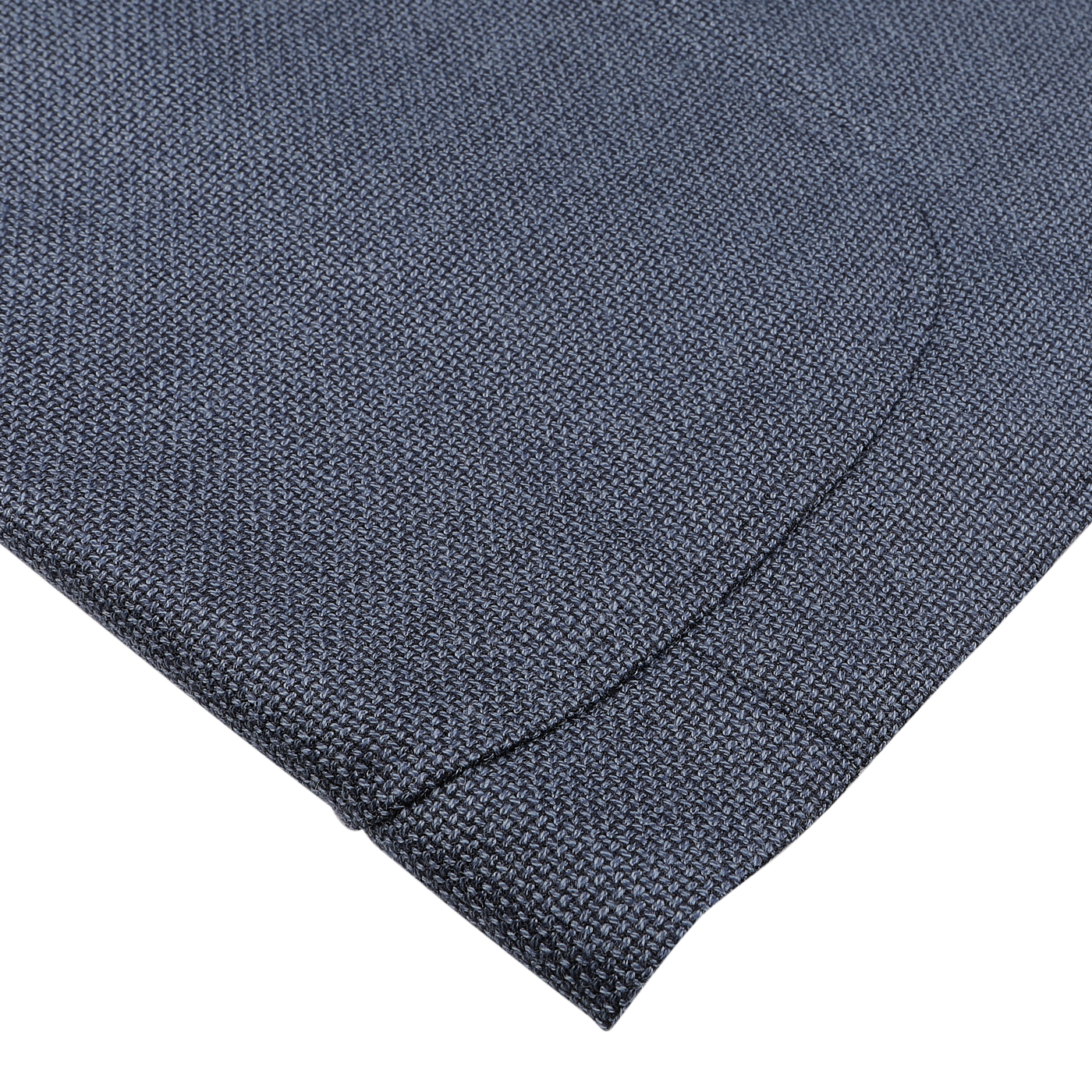 Close-up of a folded Denim Blue Wool Balloon Travel Blazer by Ring Jacket, showcasing its textured fabric against a light gray background.