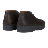 A pair of Sanders Dark Brown Savage Grain Hi Top Chukka Boots with a rubber sole.