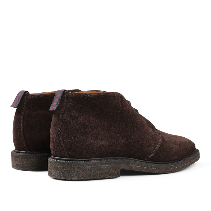 The Sanders Mocha Reverse Suede Harry Chukka Boots come with dark soles and striped pull tabs at the back.