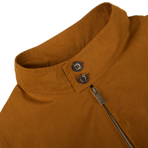 Partial view of a tobacco brown Sealup Cotton Harrington Waxed Jacket with a collar and zipper.