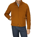 Man in a Sealup Tobacco Brown Cotton Harrington Waxed Jacket and blue jeans with hands in pockets.