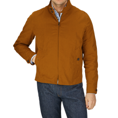 Man in a Sealup Tobacco Brown Cotton Harrington Waxed Jacket and blue jeans with hands in pockets.