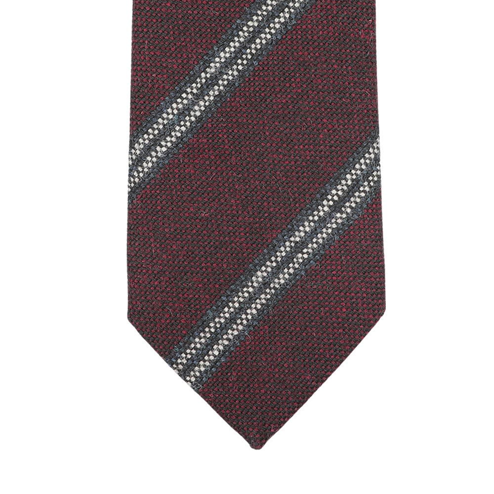 Handmade in England by Seaward & Stearn, the Burgundy Blue Striped Wool Tie showcases an elegant close-up of its diagonal blue and white stripes.