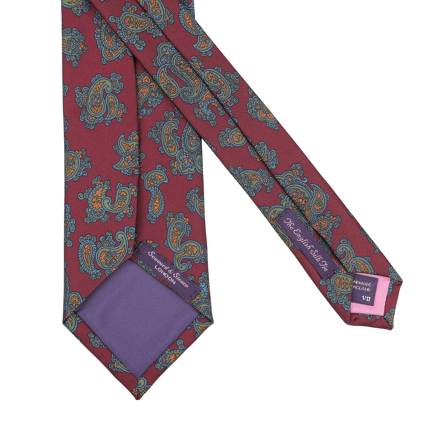 This Burgundy Paisley Printed Silk Tie by Seaward & Stearn is a handmade silk masterpiece. It features a red paisley design accentuated with blue and orange patterns, complemented by a luxurious purple lining and a discreet logo on the inner side.