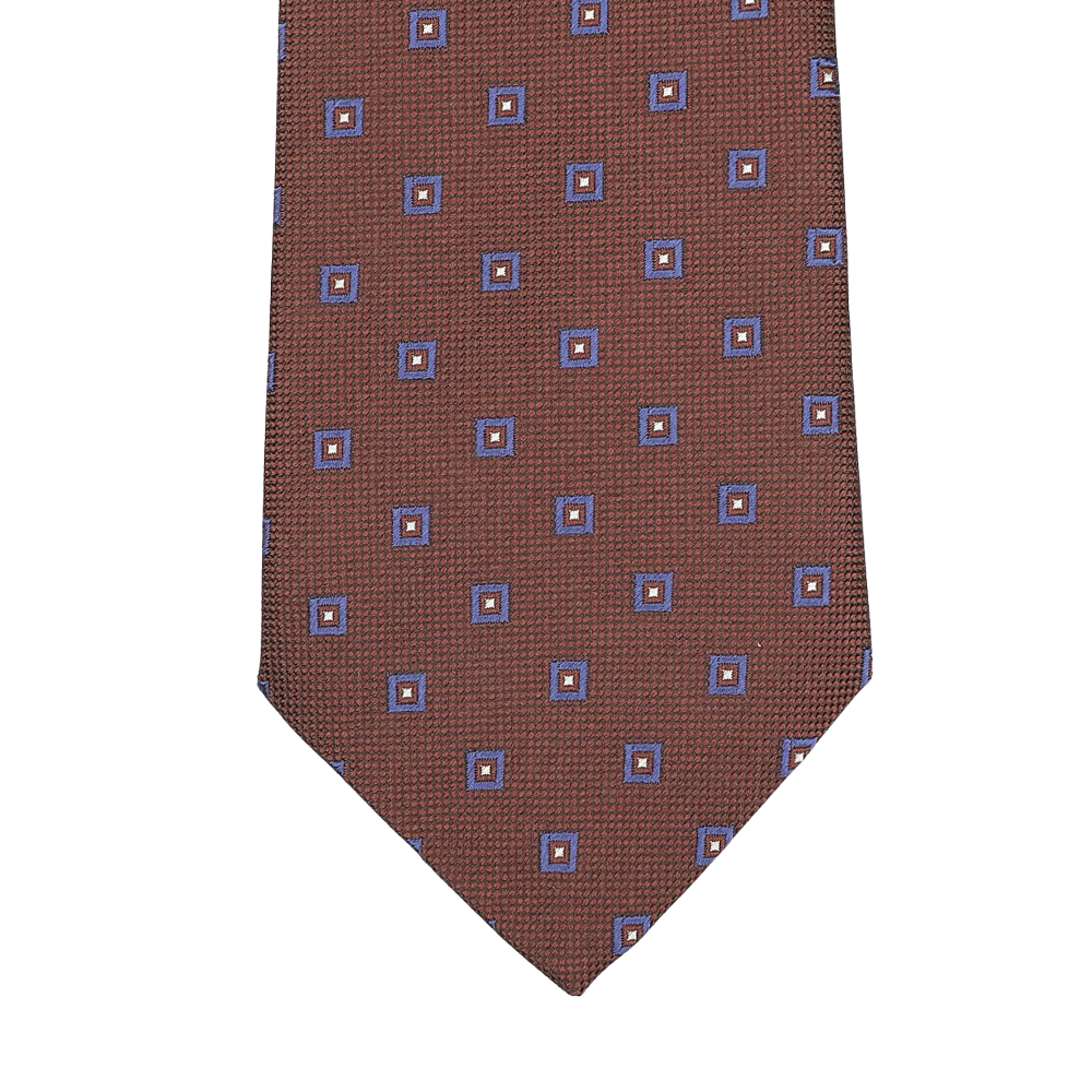 Close-up of Seaward & Stearn’s Cinnamon Brown Geometric Printed Silk Tie, featuring a stunning pattern of blue and orange squares and beautifully crafted by hand.