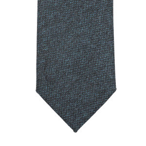 Dark blue woven tie with a pointed tip, handmade in England from pure wool by Seaward & Stearn.