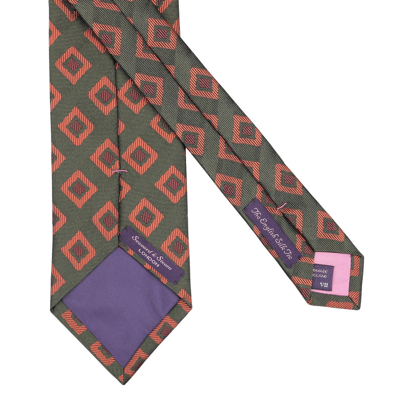 A Seaward & Stearn handmade silk tie, named the Green Orange Geometric Silk Tie, with a red geometric pattern on a dark background, featuring purple labels and a charming purple tip.