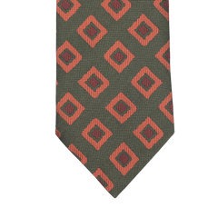 A Seaward & Stearn tie, known as the Green Orange Geometric Silk Tie, features a rich green background decorated with elegantly crafted red diamond shapes and intricate black geometric designs.