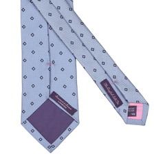 A Light Blue Diamond Woven Silk Tie by Seaward & Stearn, crafted in England from silk, features diamond patterns, a purple inner lining, and has the brand labels on the underside.