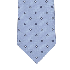 A light blue silk tie from Seaward & Stearn, featuring a pattern of small navy square dots arranged in a grid, expertly handmade in England.