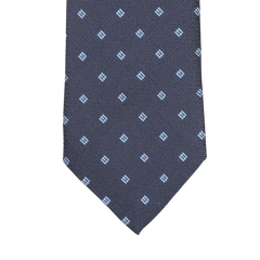 The Seaward & Stearn Navy Blue Diamond Woven Silk Tie is a handmade silk masterpiece, showcasing a navy blue color with an intricate pattern of small light blue square motifs.