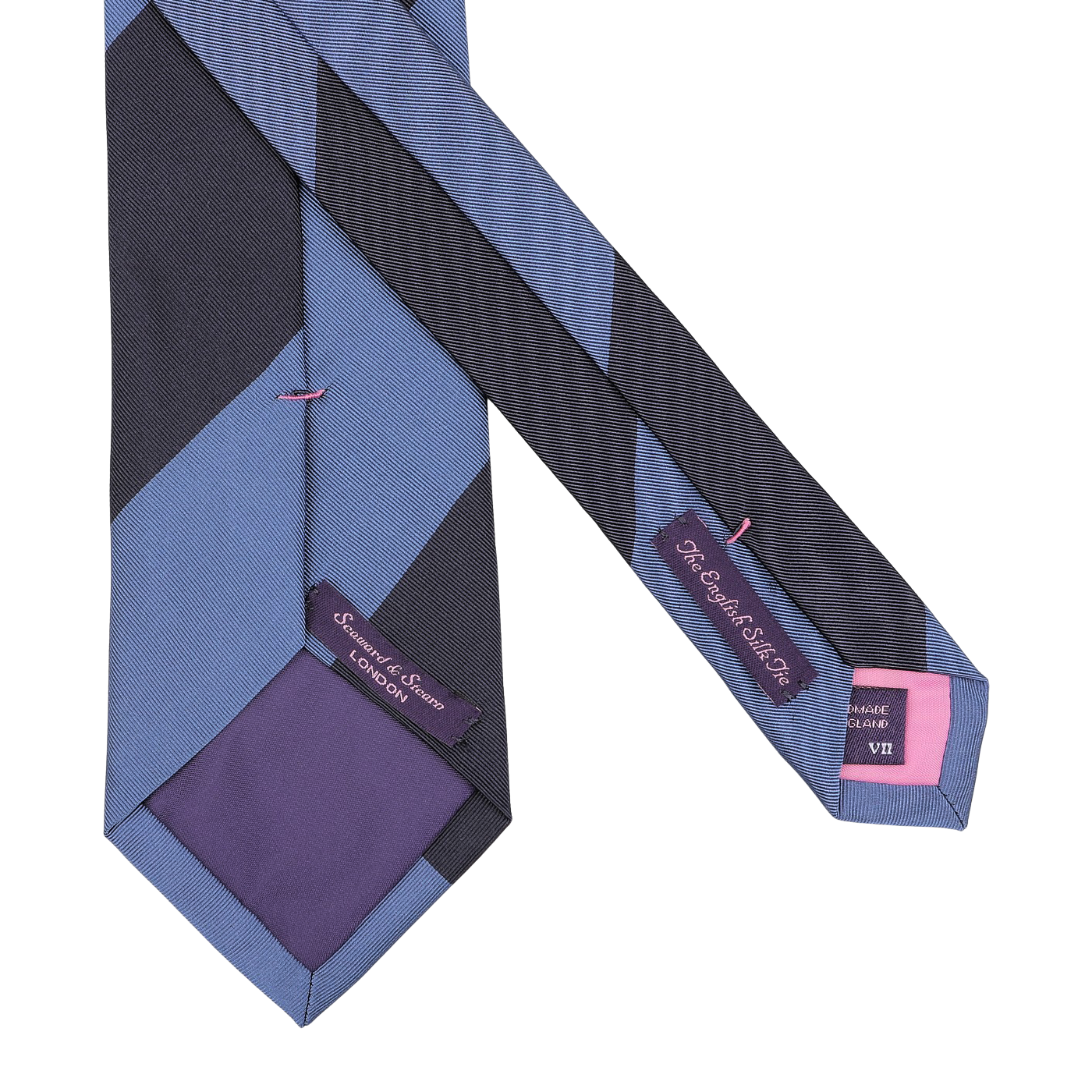 Close-up of a handmade silk navy blue striped tie showcasing identifiable labels. One label reads "Seaward & Stearn." The tie is accented with a purple lining and pink stitching.