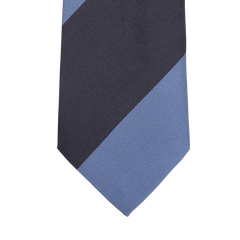 A close-up of the Seaward & Stearn Navy Blue Striped Silk Tie highlights a diagonal design with navy blue and dark gray sections against a light gray background, exemplifying the elegance of this handmade silk necktie.