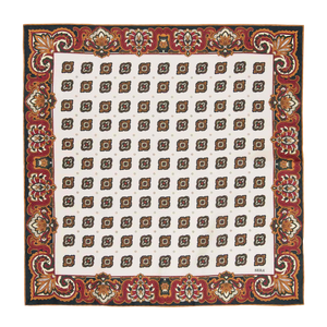 The Bucaneve White Silk Pocket Square from Sera Fine Silk is a square textile with a white background, featuring a pattern of brown and gold geometric shapes, and bordered with an ornate red floral design.