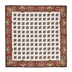 The Bucaneve White Silk Pocket Square from Sera Fine Silk is a square textile with a white background, featuring a pattern of brown and gold geometric shapes, and bordered with an ornate red floral design.