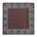 The Chocolate Recioto Silk Pocket Square by Sera Fine Silk is a square, brown paisley-patterned luxury silk pocket square, featuring intricate blue and yellow border detailing, made in Italy.