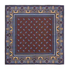 The Chocolate Recioto Silk Pocket Square by Sera Fine Silk is a square, brown paisley-patterned luxury silk pocket square, featuring intricate blue and yellow border detailing, made in Italy.