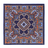 Introducing the Licorice Barolo Silk Pocket Square by Sera Fine Silk, featuring an intricate symmetrical pattern in shades of blue, orange, and beige on a navy background. This exquisite design incorporates both floral and geometric elements, crafted from Pure Como silk with meticulously hand-rolled edges.