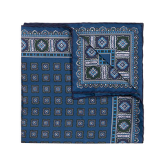 The Salt Primitivo Silk Pocket Square by Sera Fine Silk features intricate geometric patterns in shades of blue, green, and white, crafted from fine Como silk.