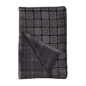 A Black Geometric Wool Silk Double Sided Scarf designed by Silvio Fiorello, on a white background.