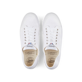 A pair of white Spring Court White Cotton Canvas G2 low-top sneakers with laces and a rubber sole on a black background.