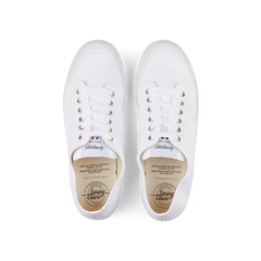 A pair of white Spring Court White Cotton Canvas G2 low-top sneakers with laces and a rubber sole on a black background.