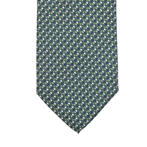 Close-up of Stefano Cau's sophisticated Bottle Green Geometrical Printed Silk Lined Tie, exquisitely crafted from luxurious Italian Como silk with green and blue pinwheels set against a dark background.