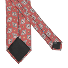 Crafted by Stefano Cau, this Brick Red Diamond Printed Silk Lined Tie is a remarkable piece featuring intricate geometric patterns and small circular accents artfully displayed on a crisp white background.