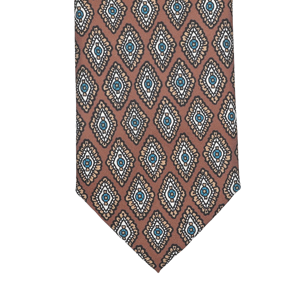 Close-up of the Stefano Cau Cinnamon Brown Medallion Printed Silk Lined Tie, featuring a geometric pattern in brown, blue, and beige tones crafted from luxurious Italian Como silk.