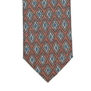 Close-up of the Stefano Cau Cinnamon Brown Medallion Printed Silk Lined Tie, featuring a geometric pattern in brown, blue, and beige tones crafted from luxurious Italian Como silk.