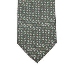 A close-up of a Stefano Cau Grass Green Square Printed Silk Lined Tie, featuring a geometric pattern with interlocking shapes in green, blue, and tan hues.