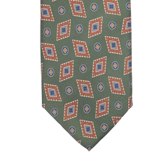 Made from luxurious Italian Como silk, the Green Diamond Printed Silk Lined Tie by Stefano Cau features a geometric design with brown-bordered diamonds and small blue circles.