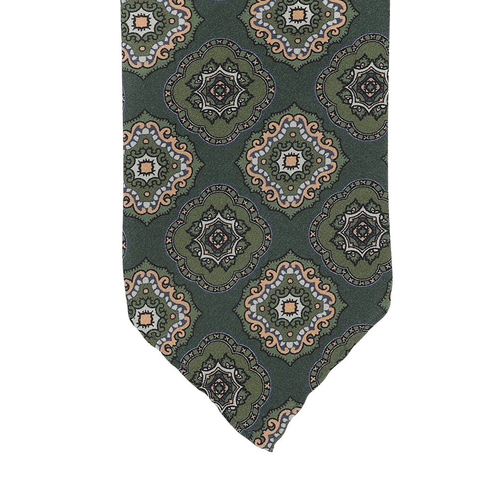 Stefano Cau's Green Medallion Printed Silk Unlined Tie is meticulously crafted from the finest Italian Como silk and showcases a repeating pattern of ornate circular designs in beige, blue, and orange tones.