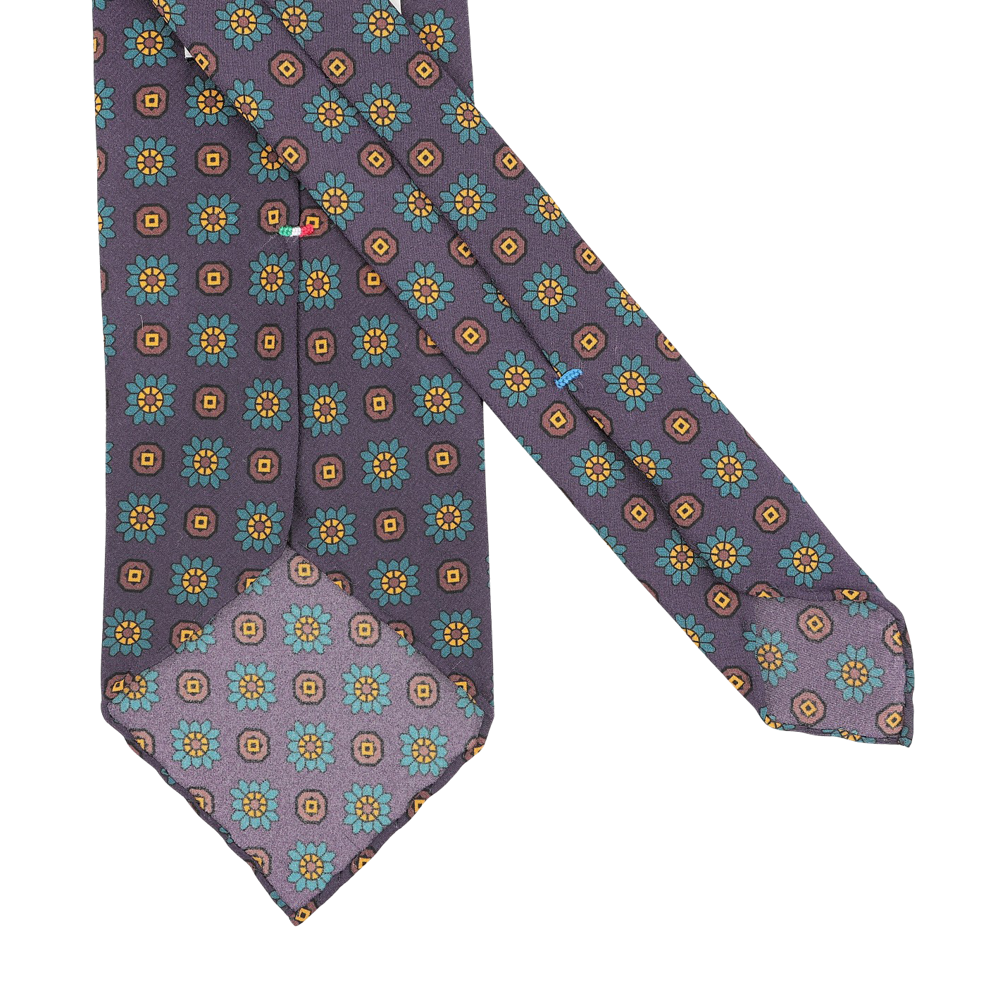 The Stefano Cau Purple Flower Printed Silk Unlined Tie is an exquisite accessory crafted from luxurious Italian Como silk, featuring a vibrant floral and geometric pattern in teal, yellow, and orange set against a plain white background—perfect for elevating any sophisticated ensemble.