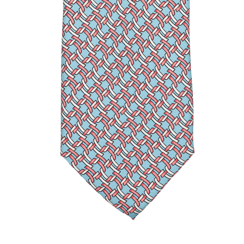 The Sky Blue Chain Printed Silk Lined Tie by Stefano Cau features a geometric design with red lines and blue shapes on a sky blue background, expertly crafted from luxurious Italian silk.