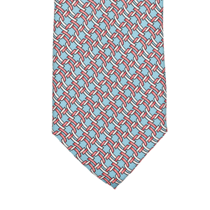 The Sky Blue Chain Printed Silk Lined Tie by Stefano Cau features a geometric design with red lines and blue shapes on a sky blue background, expertly crafted from luxurious Italian silk.