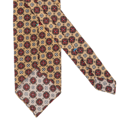 Made from premium Italian Como silk, the Yellow Flower Printed Silk Unlined Tie by Stefano Cau showcases a stylish beige pattern of red and brown circular floral motifs highlighted by subtle white flowers.