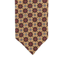 This Stefano Cau tie, crafted from luxurious Italian Como silk, showcases a beige design embellished with red and black floral patterns.