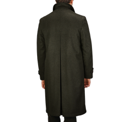 A person wearing a Steinbock Dark Green Wool Alpaca Loden Coat stands with their back turned to the camera.