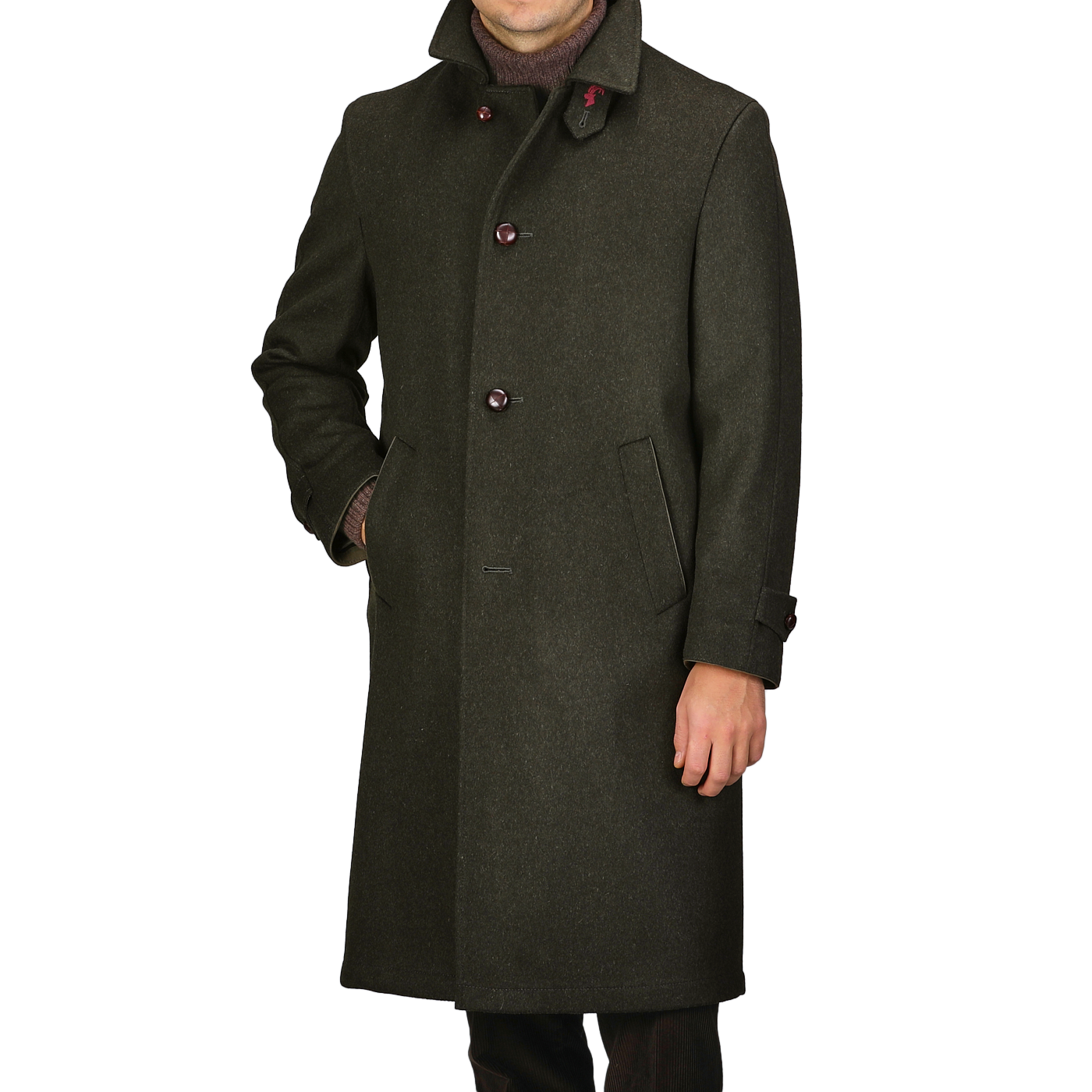 A man wearing the Dark Green Wool Alpaca Loden Coat by Steinbock, crafted from a premium wool-alpaca blend, showcases leather football buttons and practical side pockets.