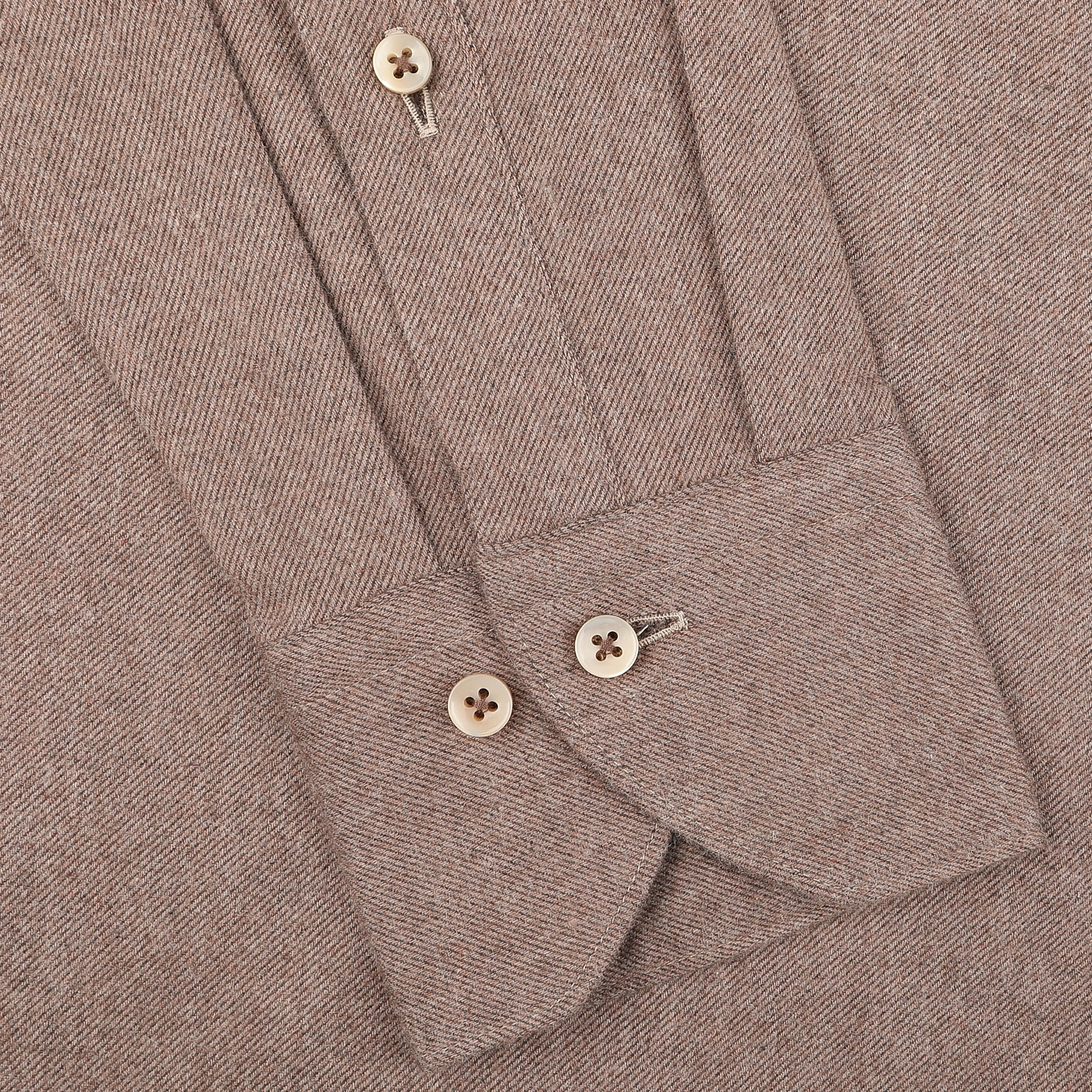 Close-up of the Stenströms Brown Cotton Flannel Cut-Away Slimline Shirt, showcasing a textured pattern and cuffs with two beige buttons.