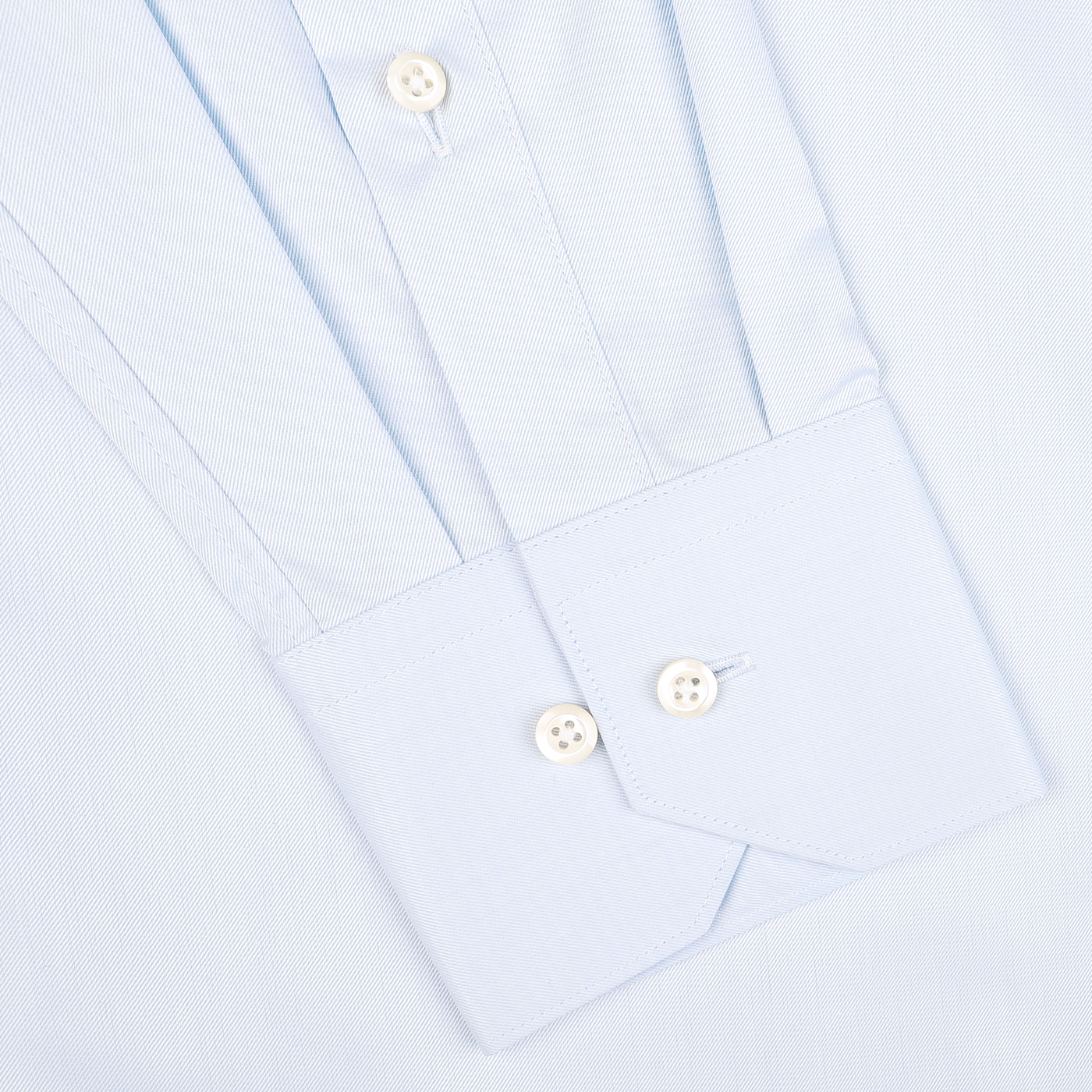 Close-up of a Light Blue Cotton Twill Fitted Body Shirt sleeve by Stenströms, featuring white buttons and a subtle vertical stripe pattern. Made from pure cotton twill, this shirt offers a fitted body cut for an elegant silhouette.