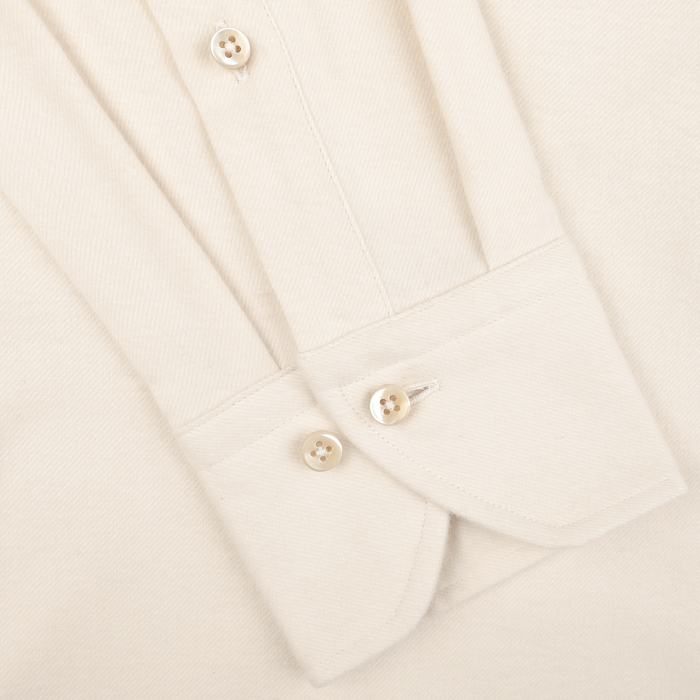 Close-up of a cuff from the Stenströms Cream Cotton Flannel Slimline BD Shirt, featuring four white buttons and made from a light brushed cotton twill fabric.