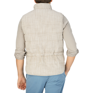 The back view of a man wearing a Beige Herringbone Cotton Linen Down Padded Gilet, a layering piece from Stenströms.