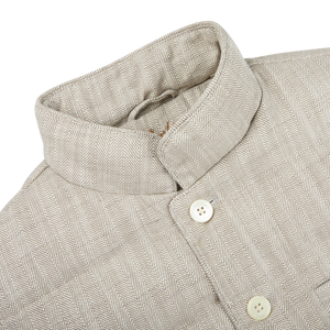 A beige linen jacket with front buttons, ideal for layering or as a lightweight outerwear option by Stenströms.