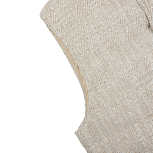 A close up of a Stenströms Beige Herringbone Cotton Linen Down Padded Gilet on a white surface.