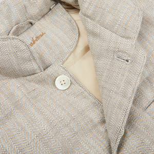 A close up of a Stenströms Beige Herringbone Cotton Linen Down Padded Gilet with buttons.